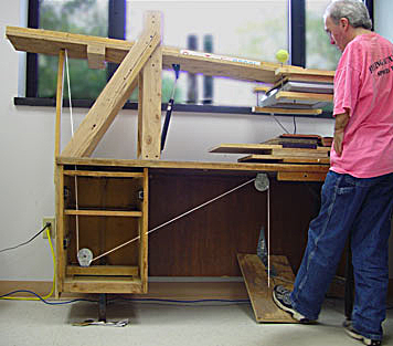 The cable and pulley system activated by Tim